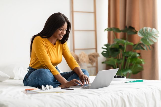 woman emailing hotel for early check in